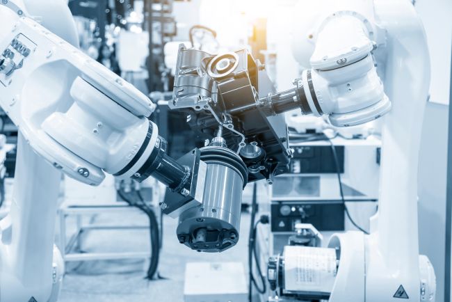 An illustrative image showcases an industrial robot engaged in precision manufacturing tasks, embodying the theme "Precision Automation: Integrating Industrial Robotics with High-Precise Machine Tools." The robot, with its sleek, articulated arms, is depicted with meticulous detail, performing complex tasks with accuracy and efficiency. In the background, high-precision machine tools complement the robot's actions, highlighting the seamless integration of robotics and advanced manufacturing technologies. This visual encapsulates the innovation and sophistication in modern automation, illustrating the future of industrial production where precision and collaboration between machines enhance productivity and quality.